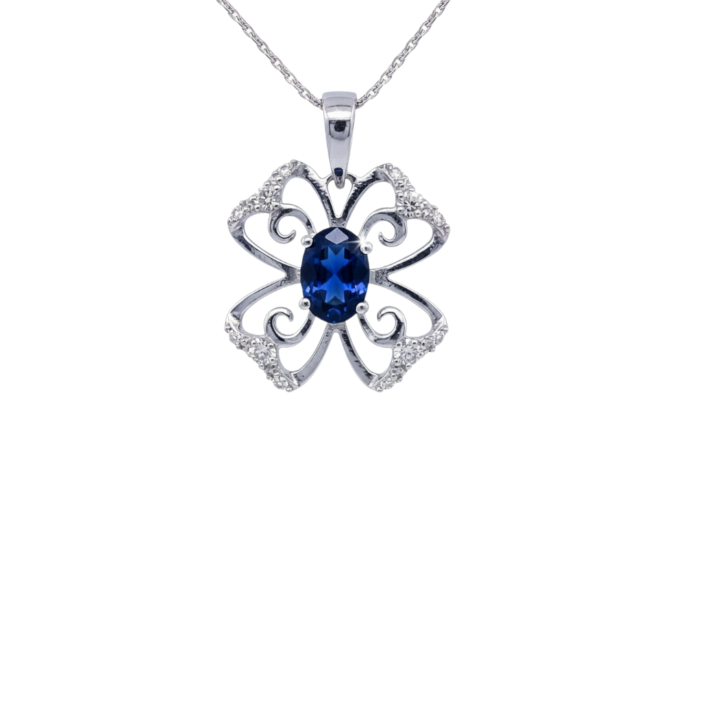 Caribbean Gems 14kt white gold pendant featuring an oval sapphire and diamond accents in a floral filigree design.