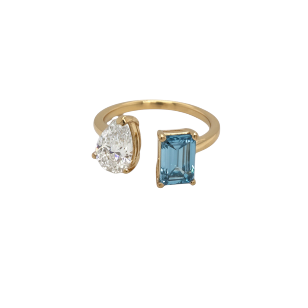 Caribbean Gems two-stone ring with a pear-cut lab diamond and emerald-cut blue stone in 14kt yellow gold