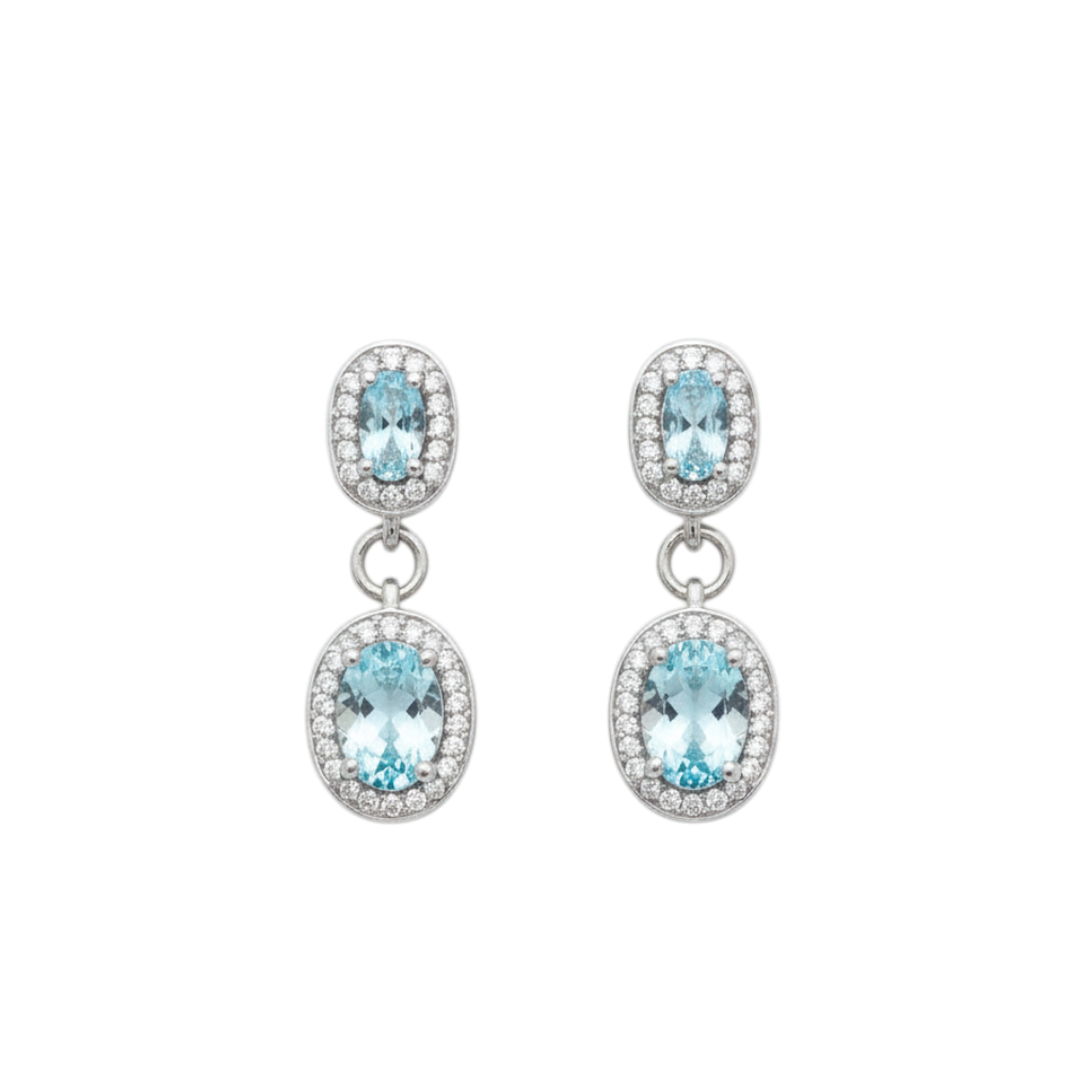 Caribbean Gems oval aquamarine and diamond drop earrings set in 18kt white gold on a neutral background.