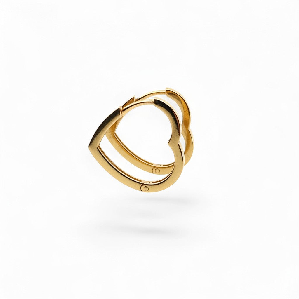 Caribbean Gems 14k yellow gold heart-shaped hoop earrings with a polished finish on a white background.