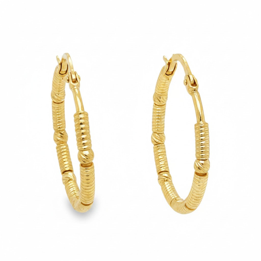 Caribbean Gems 14kt yellow gold hoop earrings featuring a textured, wrapped wire design for an elegant look.