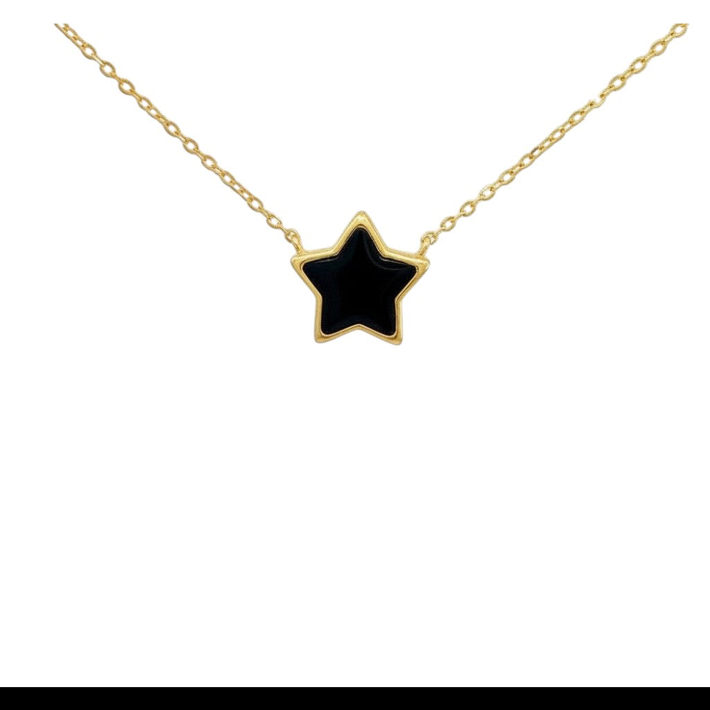 Caribbean Gems black onyx star pendant set in 14kt yellow gold on a delicate gold chain against a white background.