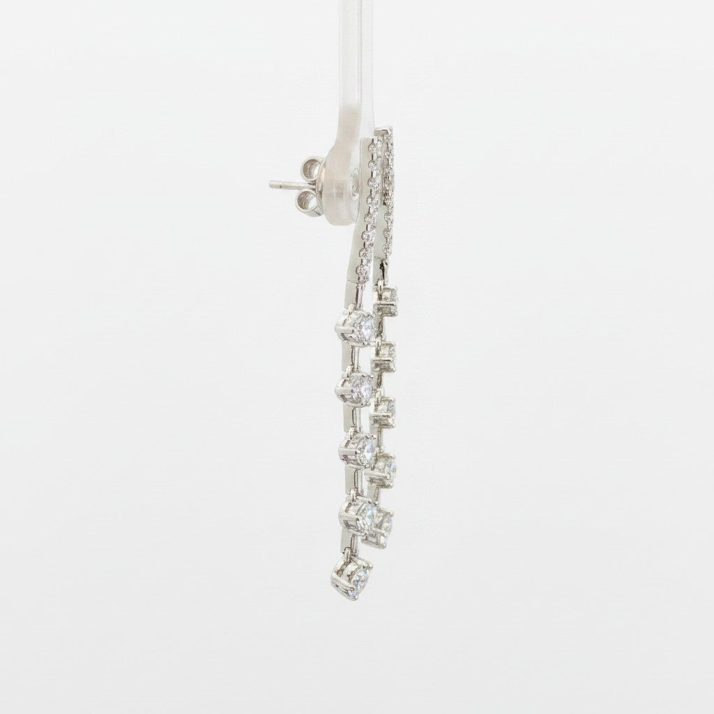 Caribbean Gems dangling diamond earrings featuring 1.22cts of round diamonds set in 14kt white gold, side view.