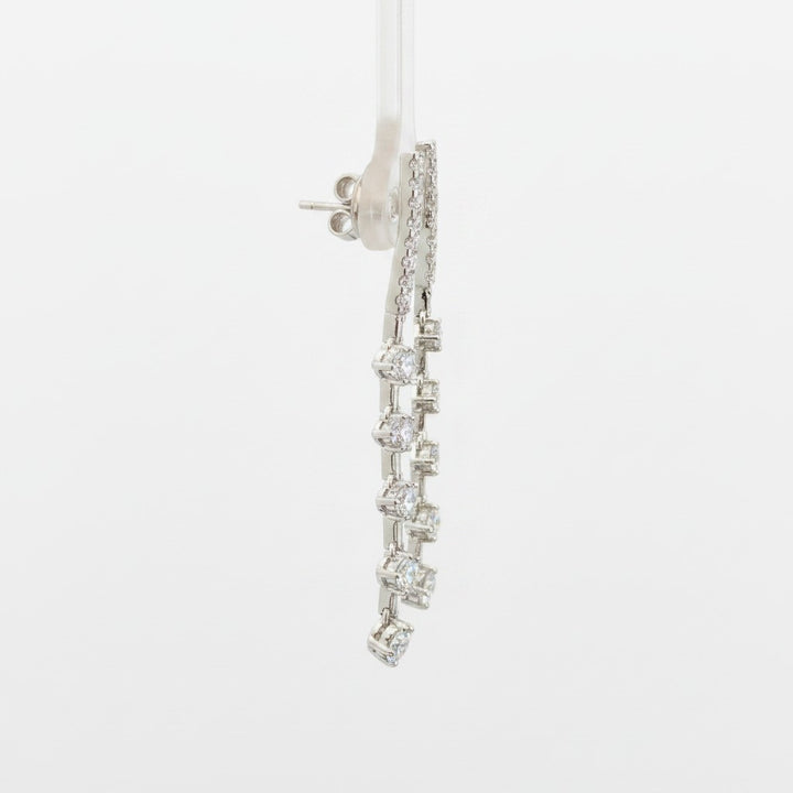 Caribbean Gems dangling diamond earrings featuring 1.22cts of round diamonds set in 14kt white gold, side view.