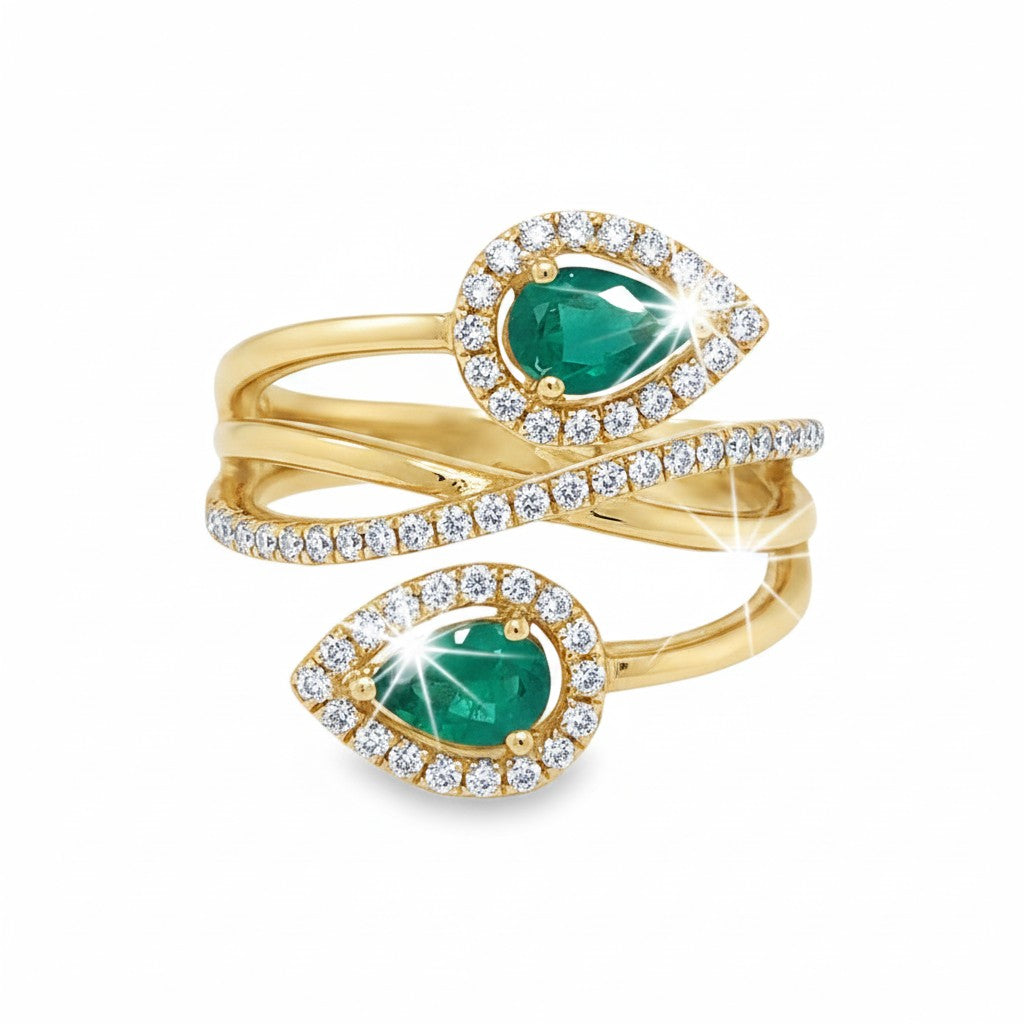 Caribbean Gems elegant 14kt yellow gold bypass ring featuring pear-shaped emeralds and sparkling round diamonds.