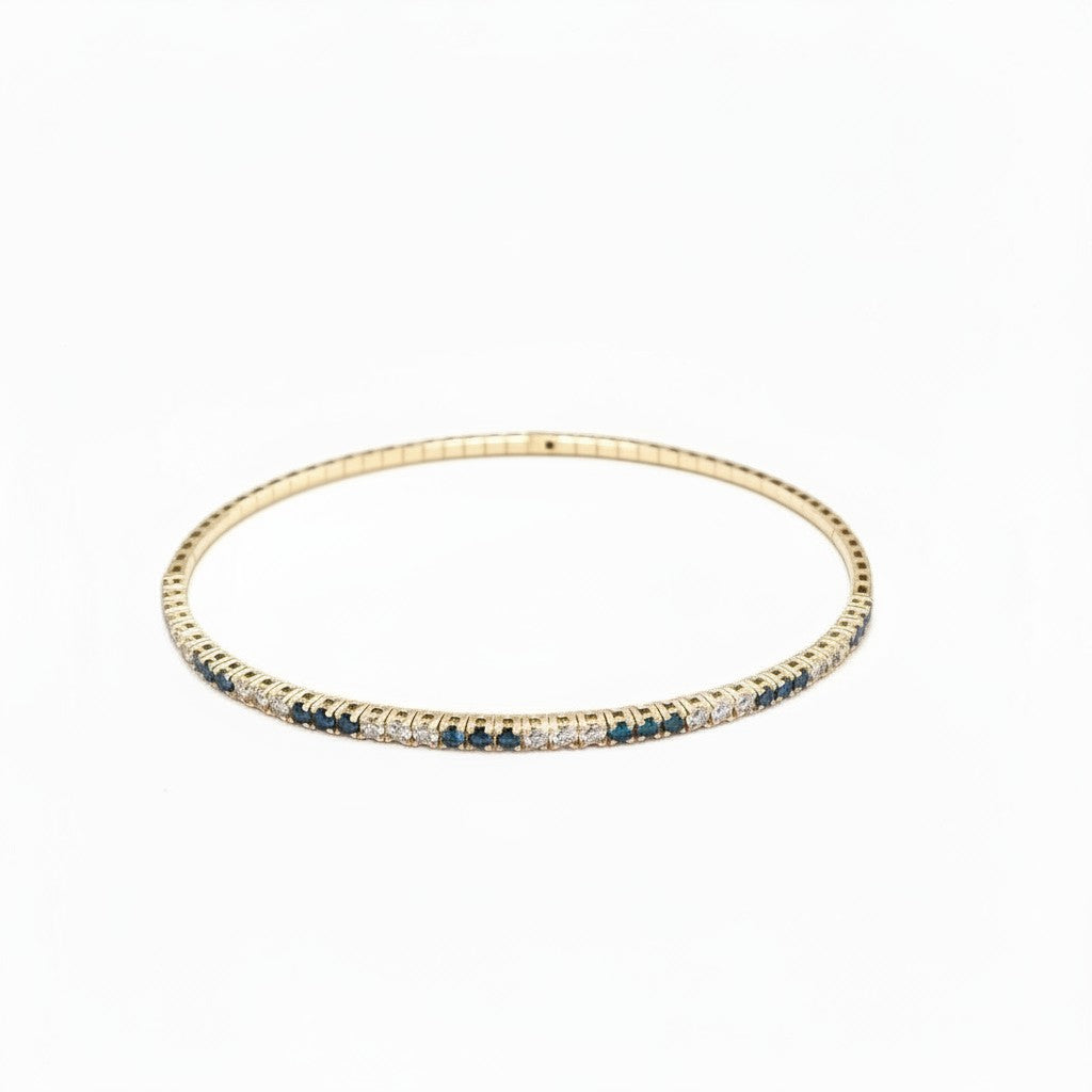 Caribbean Gems flexible 14K yellow gold bangle with alternating blue and white diamonds in a delicate setting.
