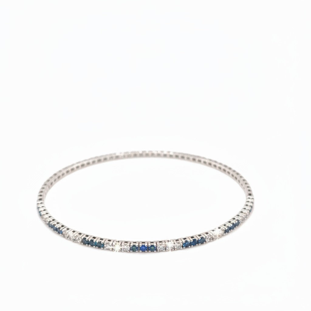 Caribbean Gems flexible 14kt white gold bangle with alternating blue and white diamonds on a white background