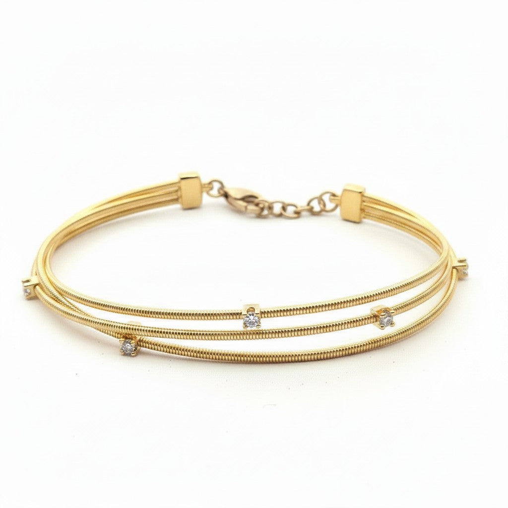 Caribbean Gems 14kt yellow gold triple-strand bangle bracelet featuring sparkling round diamonds