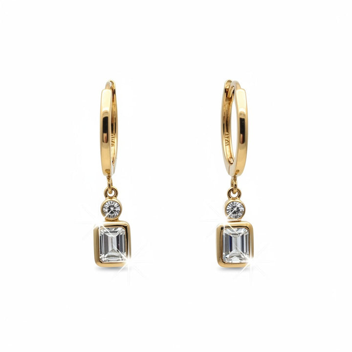 Caribbean Gems 14k yellow gold drop earrings featuring baguette and round diamonds on a white background.
