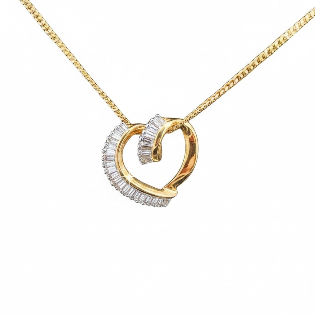 Caribbean Gems 14kt yellow gold heart pendant featuring 0.85cts of baguette cut diamonds on a gold chain.