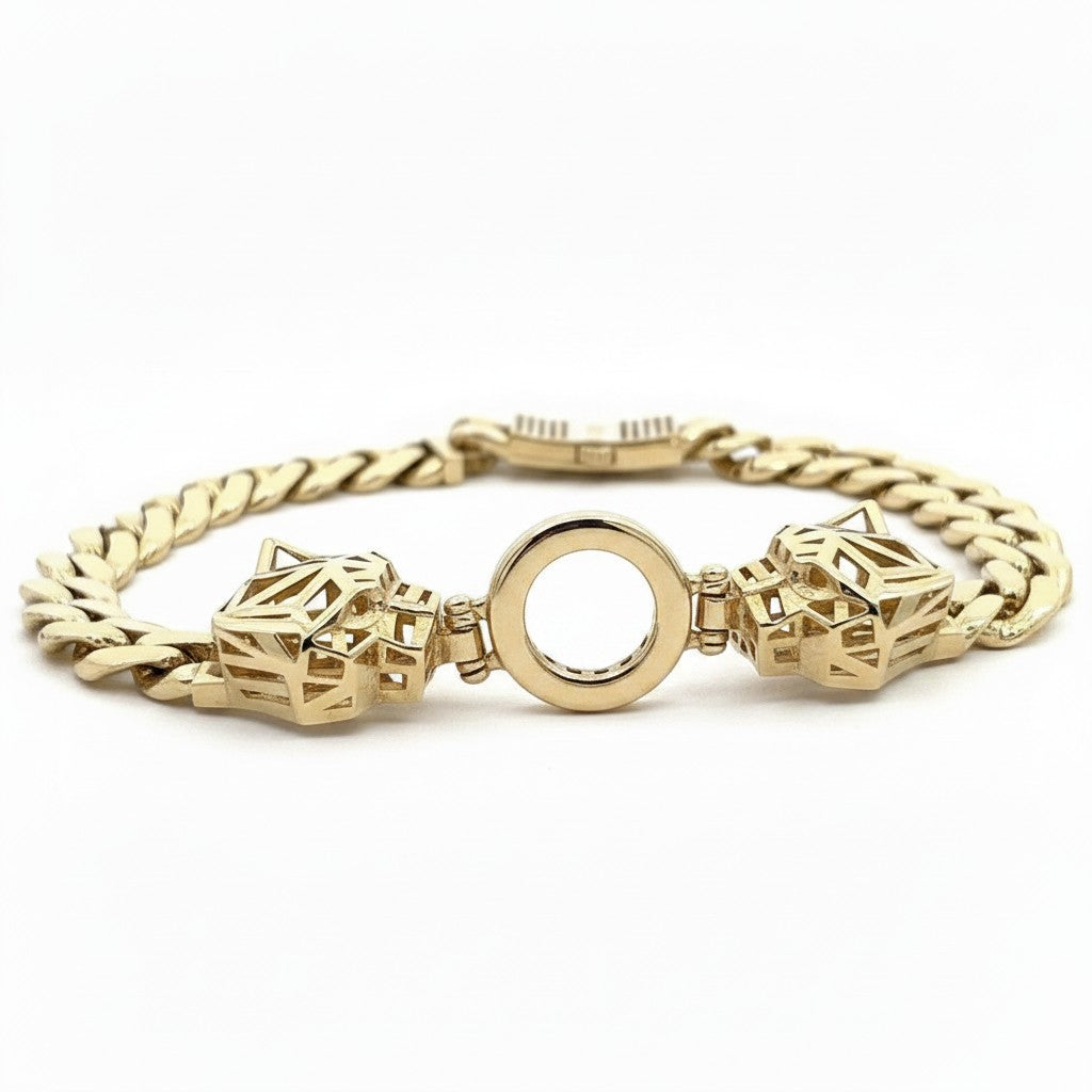 Caribbean Gems ladies gold bracelet featuring two geometric panther heads connected by a central circular ring.