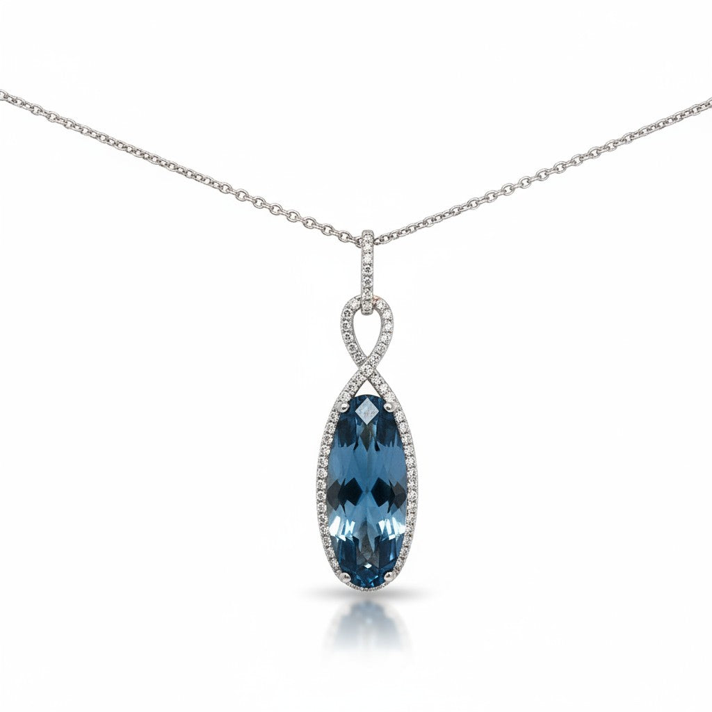 Caribbean Gems 14kt white gold pendant featuring a 7-carat oval London Blue Topaz surrounded by sparkling diamonds.