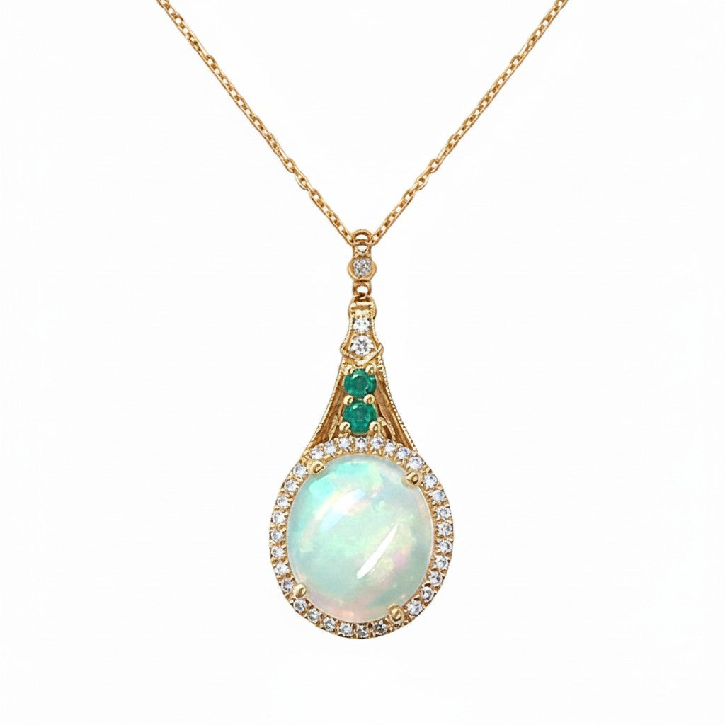 Caribbean Gems 14kt yellow gold pendant featuring a round opal, emerald accents, and a diamond halo on a gold chain.