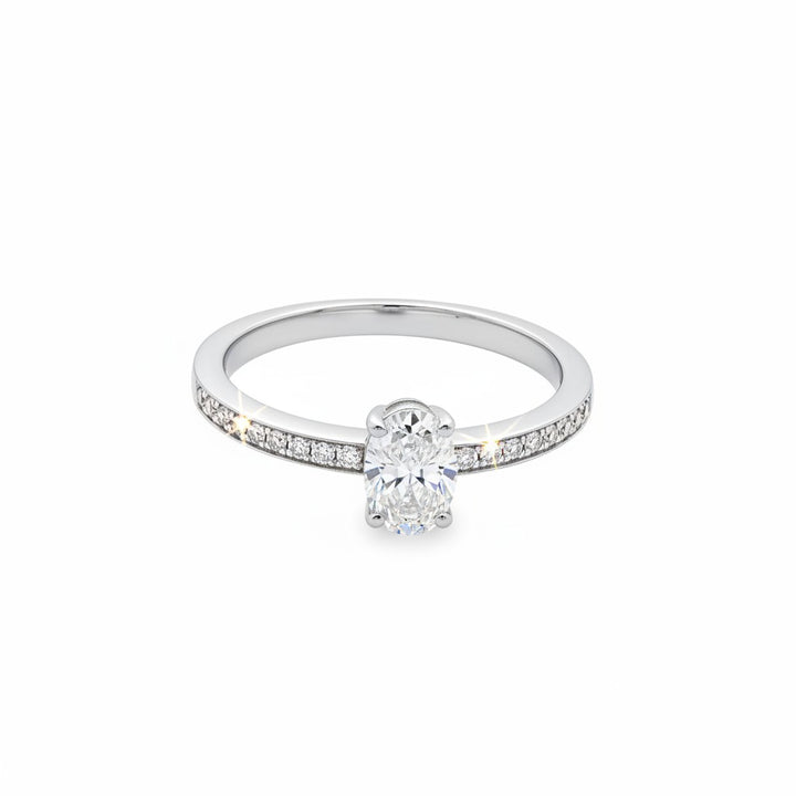 Caribbean Gems 14kt white gold ring featuring a central oval cut diamond and round cut diamond pavé band