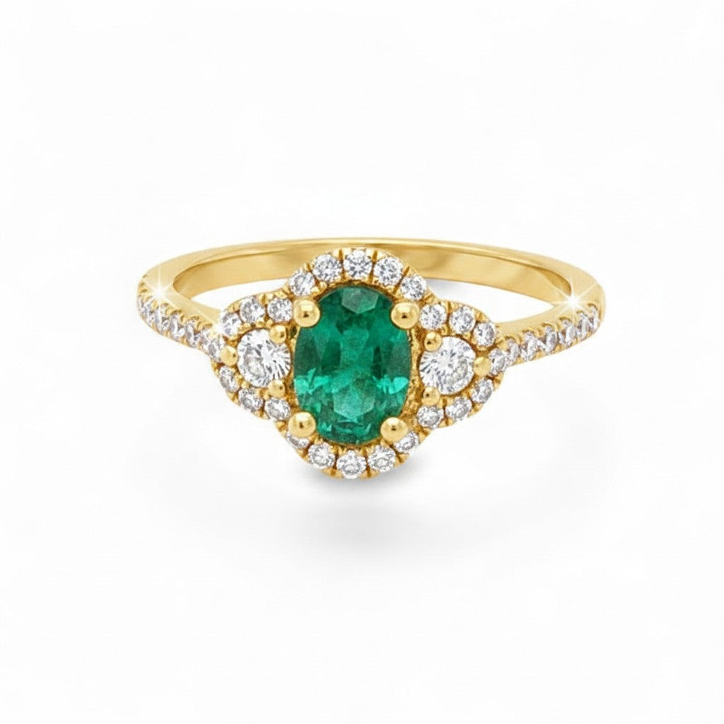 Caribbean Gems 14kt yellow gold ring with a 0.67ct oval emerald surrounded by 0.41ct round diamond halo accents.
