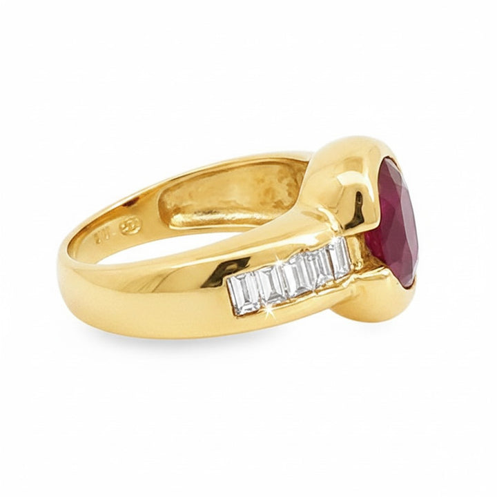 Caribbean Gems 18kt yellow gold ring featuring a 2.06ct oval ruby and baguette diamond side accents