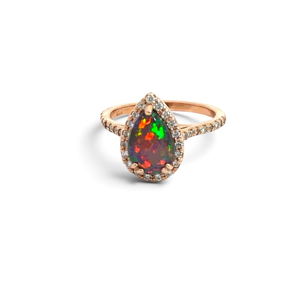 Caribbean Gems pear-shaped opal ring with diamond halo in 14kt rose gold, showcasing vibrant play of color.