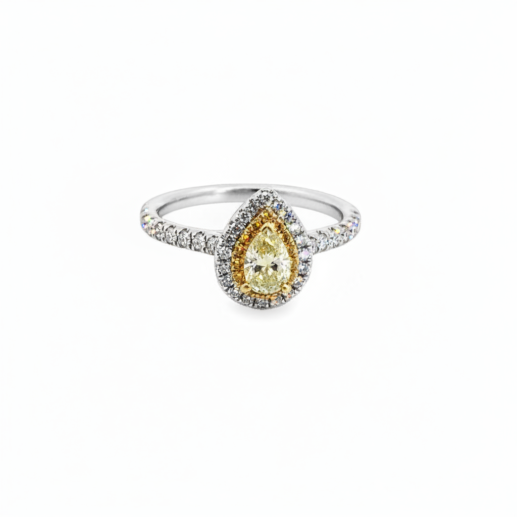 Caribbean Gems pear shaped yellow and white diamond ring set in 18kt gold with a halo design.