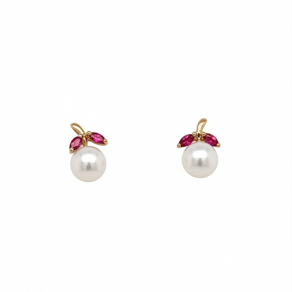 Caribbean Gems pearl and ruby stud earrings featuring marquise-cut red rubies set in gold above lustrous white pearls.