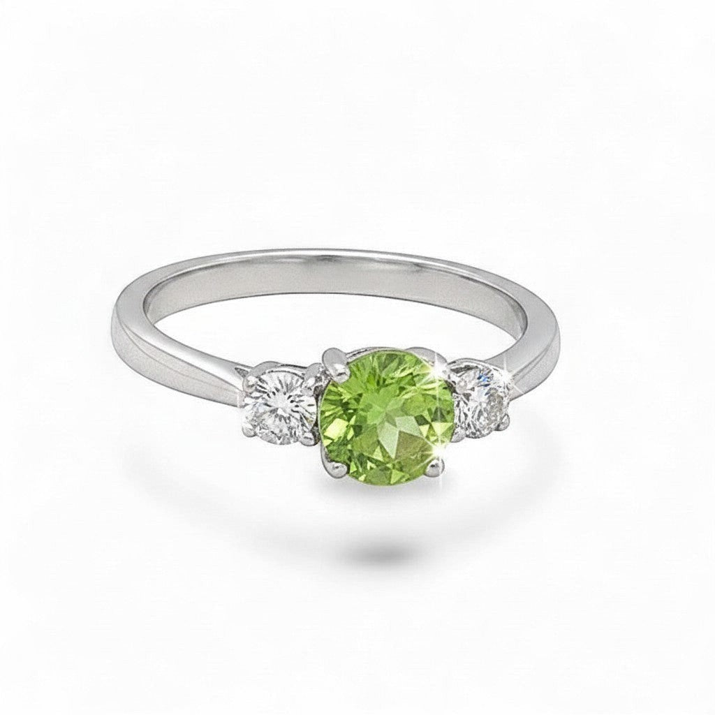 Caribbean Gems 14kt white gold ring featuring a round peridot center stone flanked by two sparkling round diamonds.