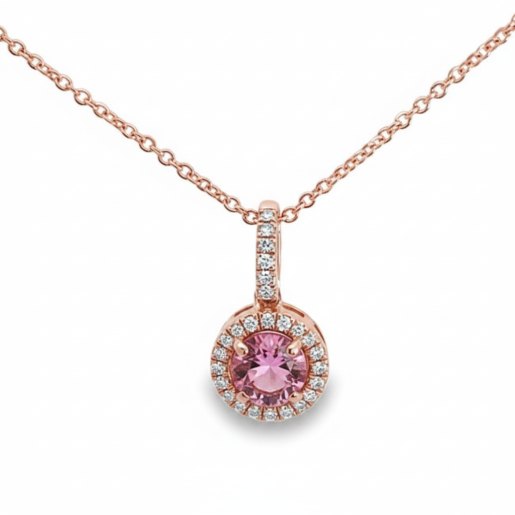 Caribbean Gems delicate 14kt rose gold pendant featuring a round pink topaz surrounded by sparkling diamond accents.