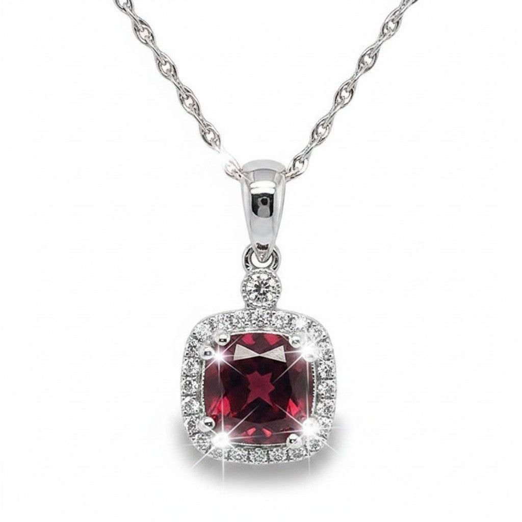 Caribbean Gems cushion-cut rhodolite pendant with diamond halo in 14k white gold on a silver chain.