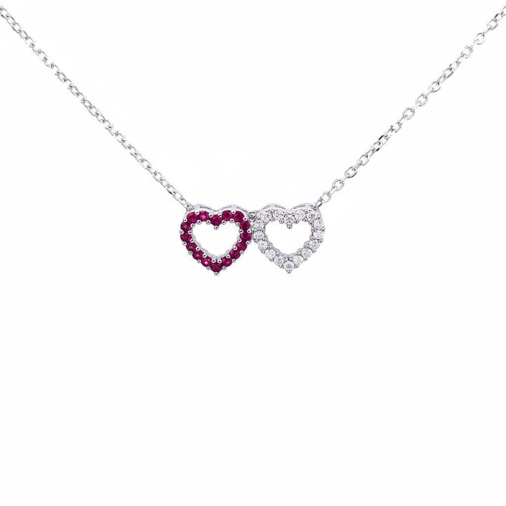 Caribbean Gems 14kt white gold two heart pendant featuring a ruby heart and a diamond heart on a delicate chain.