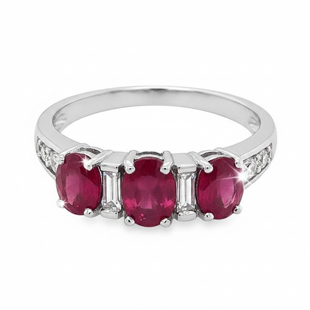 Caribbean Gems 18kt white gold ring featuring three oval rubies and baguette cut diamond accents.