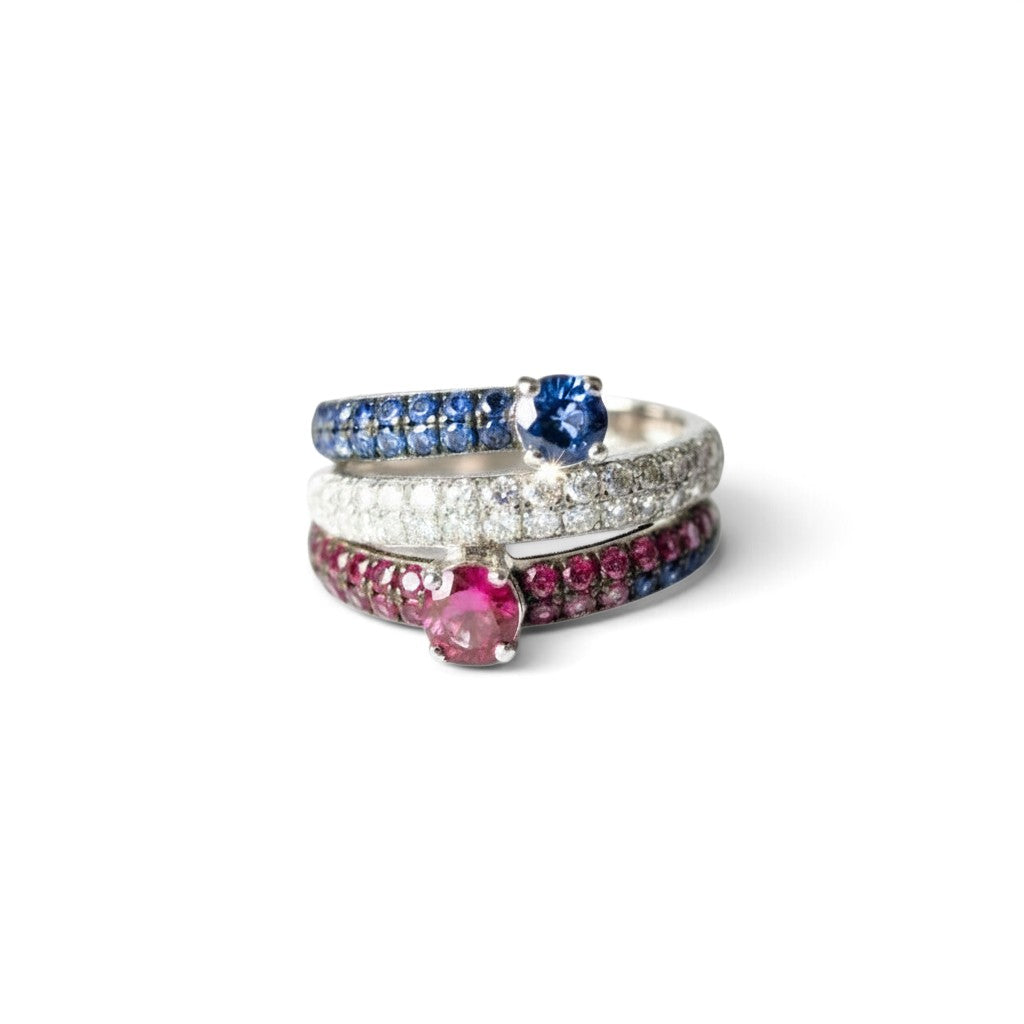 Caribbean Gems 18kt white gold ring featuring a ruby, sapphire, and diamond pavé band on a white background.