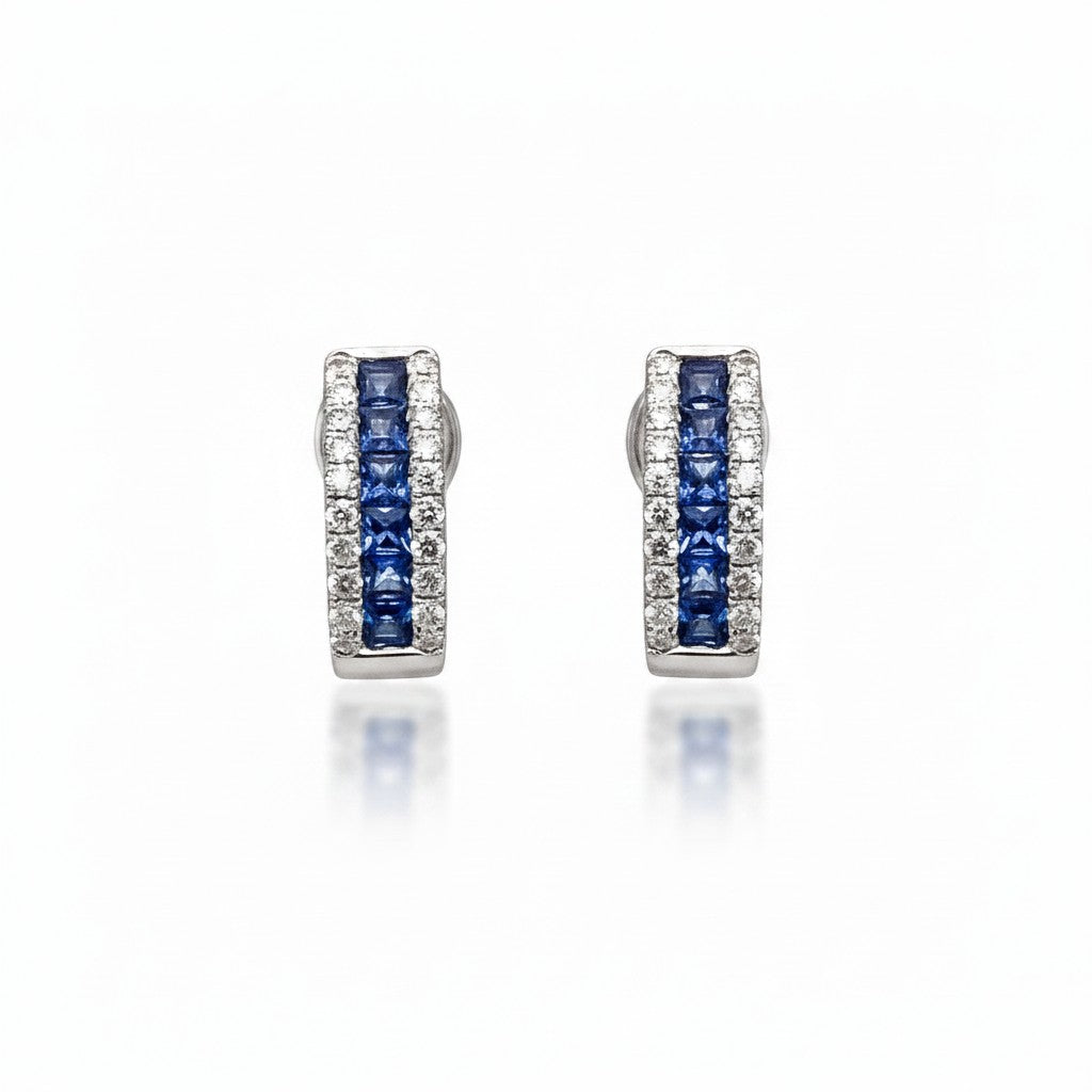 Caribbean Gems 14kt white gold hoop earrings featuring channel-set blue sapphires and sparkling diamond accents.