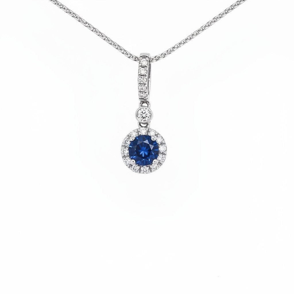 Caribbean Gems 14kt white gold pendant featuring a 0.62ct round sapphire surrounded by 0.16ct round diamond halo