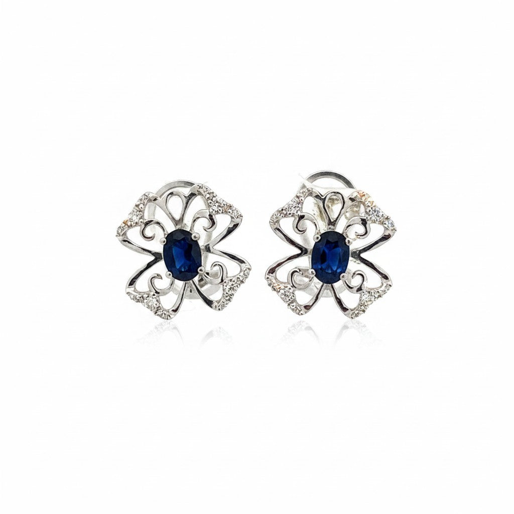 Caribbean Gems 14kt white gold stud earrings featuring oval blue sapphires and diamond accents in a floral design.