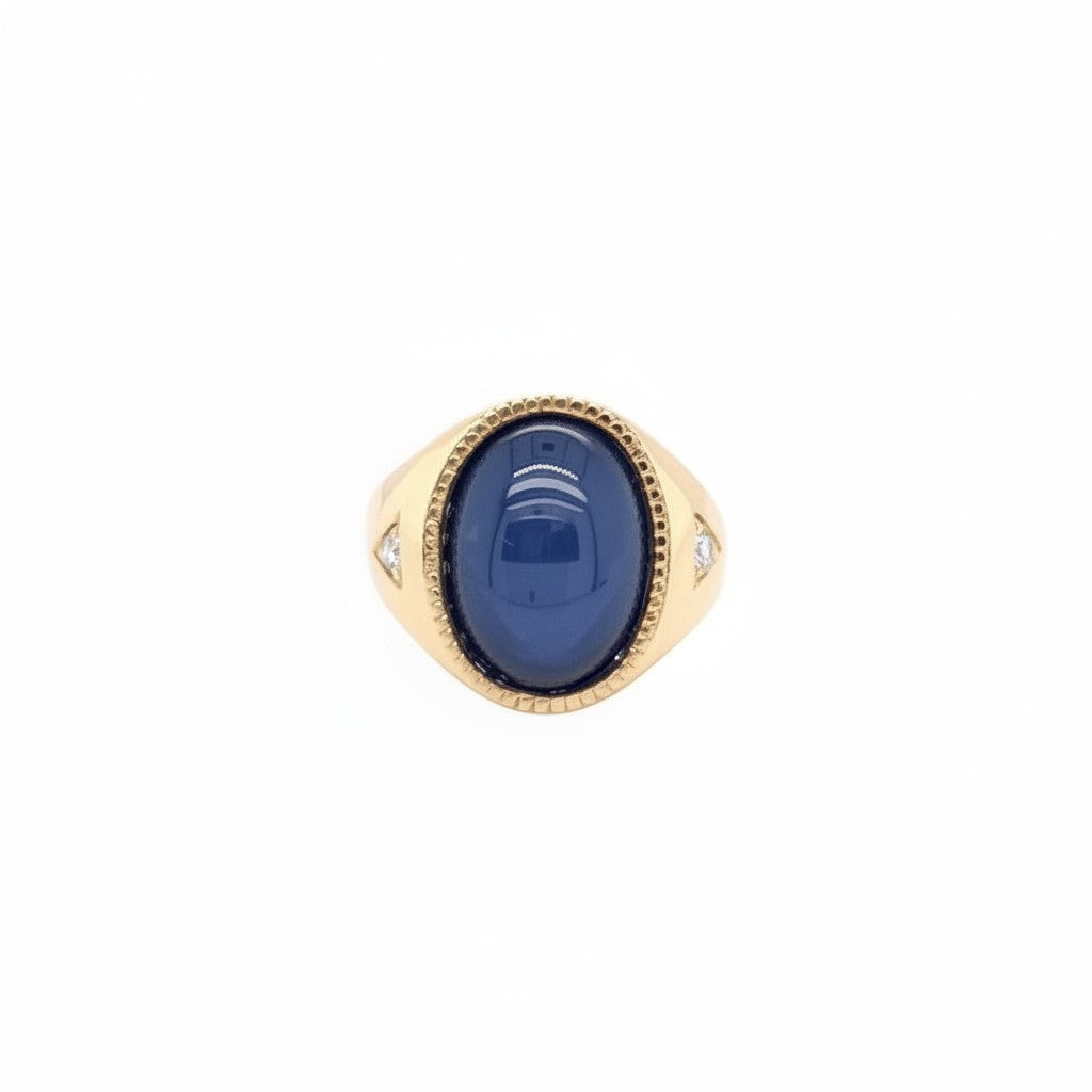Caribbean Gems men's 14kt yellow gold ring with an oval star sapphire and diamond accents on a white background.