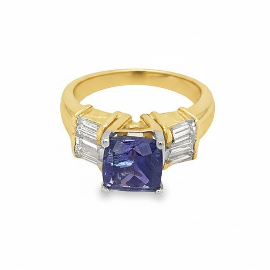 Caribbean Gems 18kt yellow gold ring featuring a 2.60ct tanzanite center stone flanked by baguette-cut diamonds.