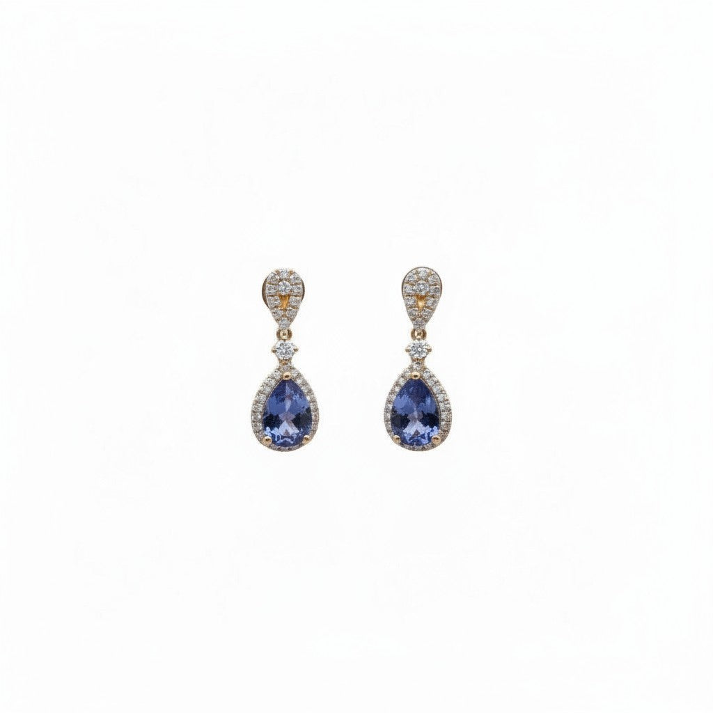 Caribbean Gems ornate drop earrings featuring pear-cut tanzanite stones and diamond halos set in 18kt yellow gold.