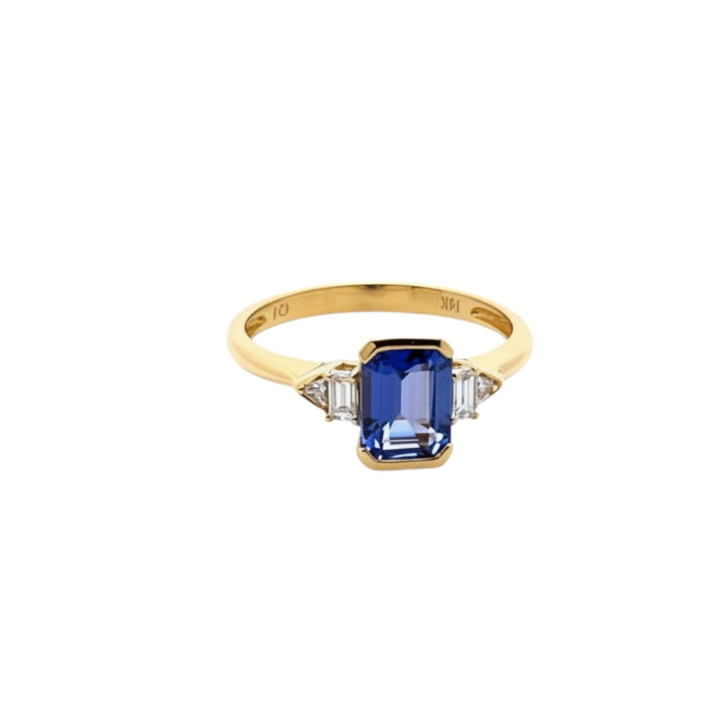 Caribbean Gems 14kt yellow gold ring featuring an emerald-cut tanzanite flanked by baguette and round diamonds.