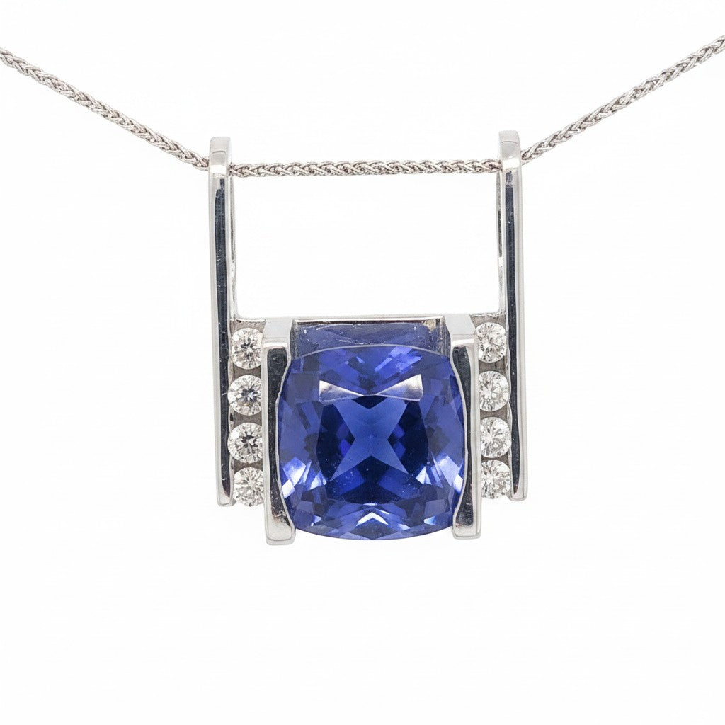 Caribbean Gems 14kt white gold pendant featuring a 10.71ct cushion-cut tanzanite and round diamond accents.