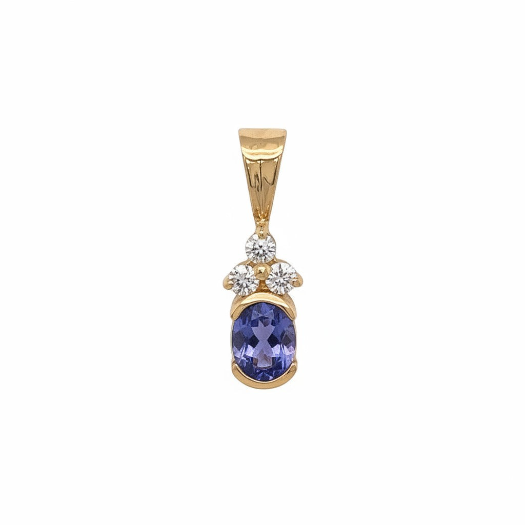 Caribbean Gems 14kt yellow gold pendant featuring an oval-cut blue-violet tanzanite and sparkling round diamonds.