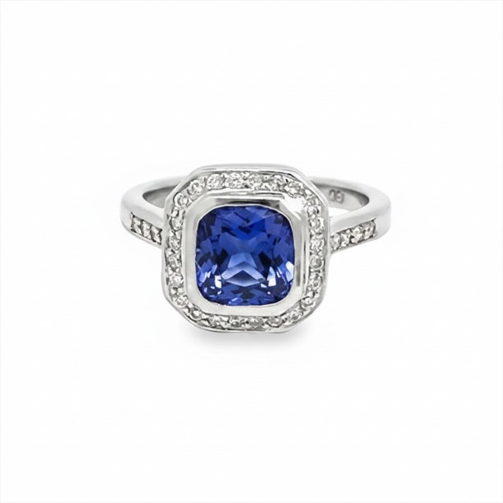 Caribbean Gems 14kt white gold ring featuring a 2.00ct cushion-cut tanzanite surrounded by round diamond accents.