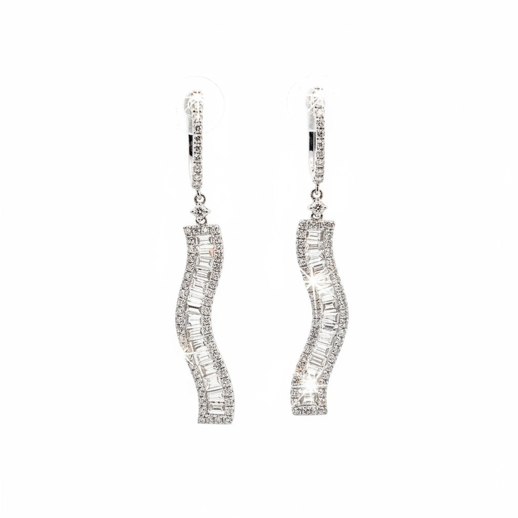 Caribbean Gems dangling earrings in 18kt white gold featuring baguette and round cut diamonds in a wavy design.