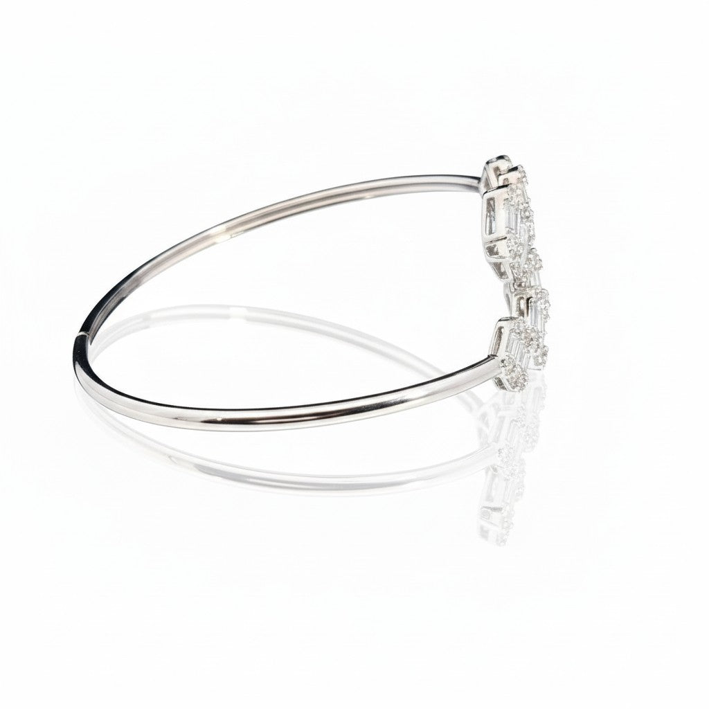 Caribbean Gems 14kt white gold bangle with baguette and round diamonds, side view showing elegant craftsmanship.
