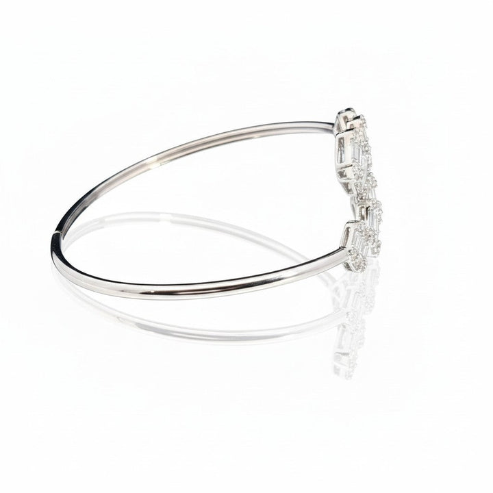 Caribbean Gems 14kt white gold bangle with baguette and round diamonds, side view showing elegant craftsmanship.