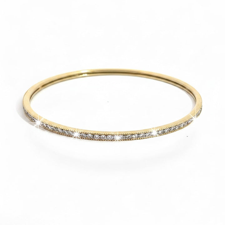 Caribbean Gems ladies 14kt yellow gold bangle featuring 1.50cts of sparkling round yellow diamonds