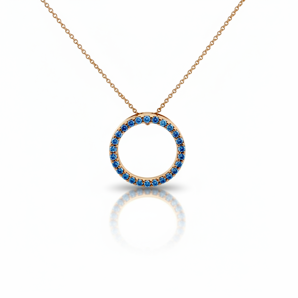 Caribbean Gems circle of life pendant featuring blue diamonds set in 14kt yellow gold on a delicate chain